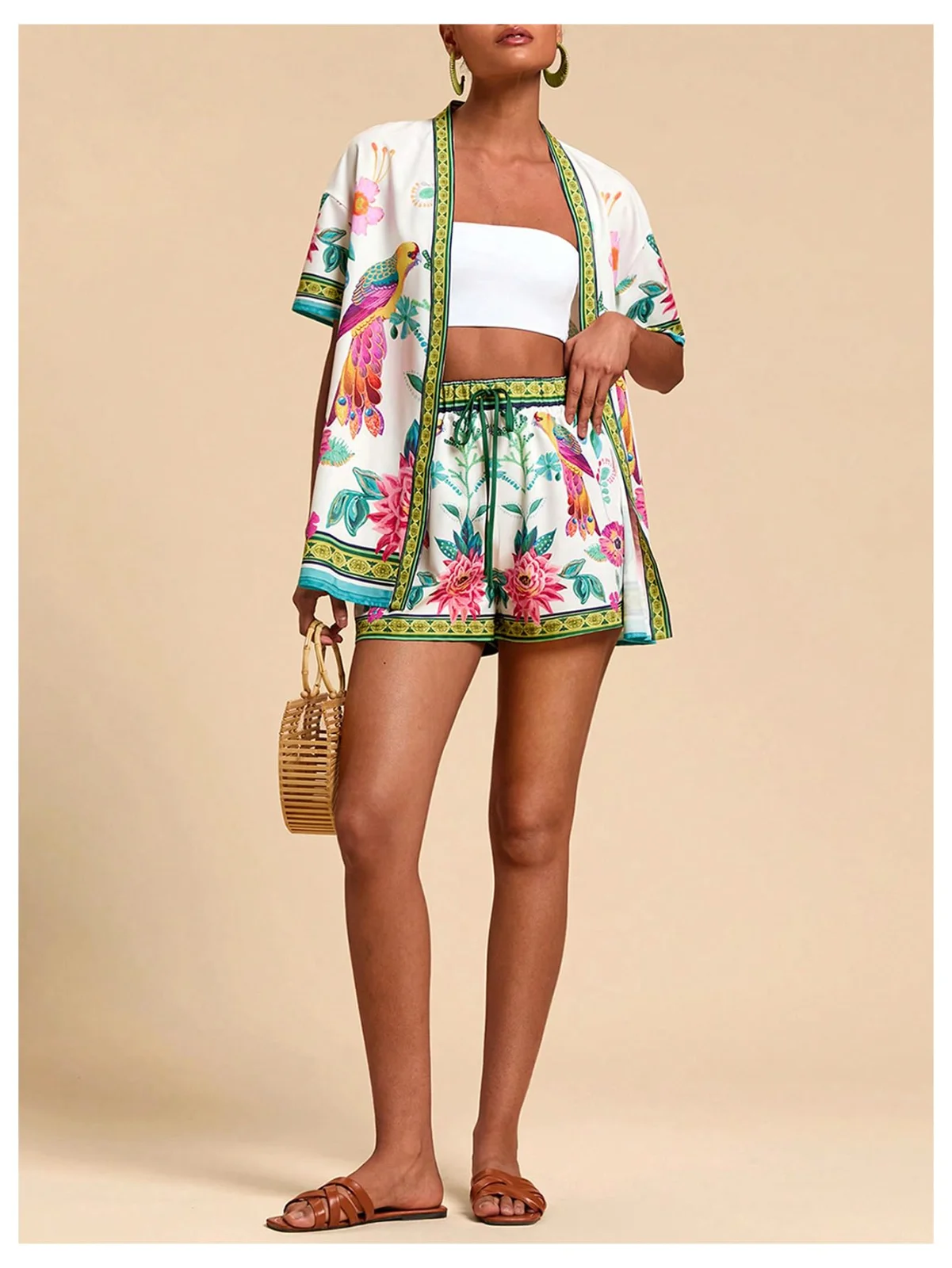 The tropical two-piece set in a parrot print, shirt open over a white tube top, with a raffia bag