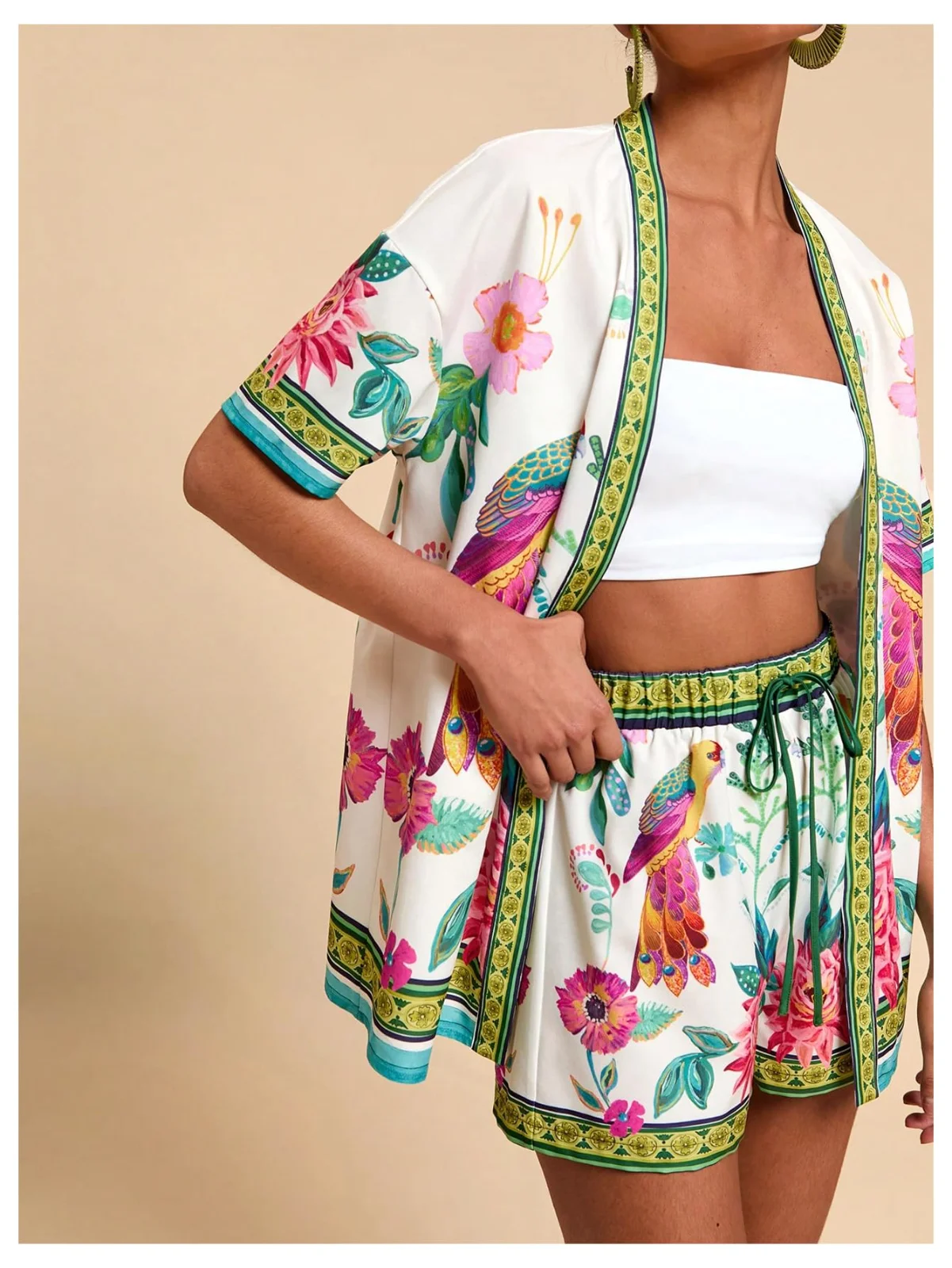The MAKEMECHIC tropical two-piece set from the back, the parrot print across the shoulders
